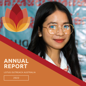 preview image of 2022 annual report - Girl in white shirt with large shiny reading glasses, smiling at the camera